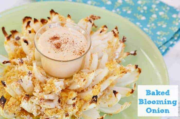 baked blooming onion with cup of sauce in the middle