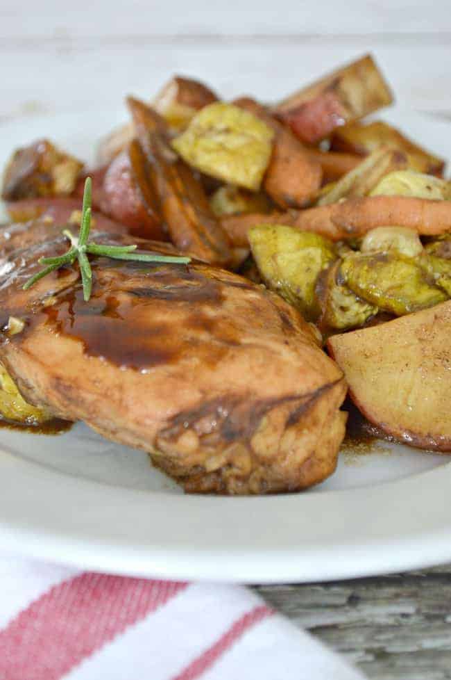 One pan balsamic chicken and roasted vegetables on white plate 