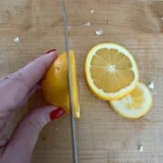 slicing oranges on a butcher block countertop