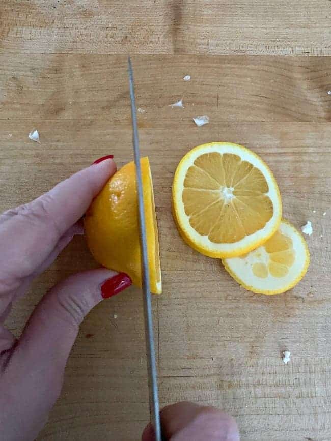 slicing oranges on a butcher block countertop