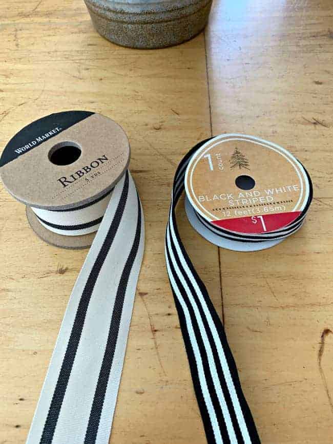 2 spools of black and white ribbon laying on table