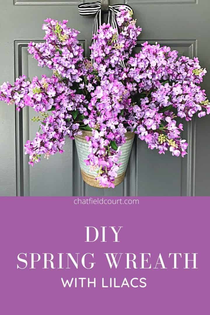 DIY lilac spring wreath hanging on dark gray door