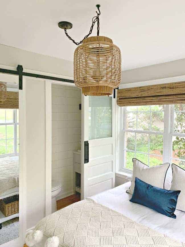 view of guest bedroom with platform bed and DIY rattan light fixture