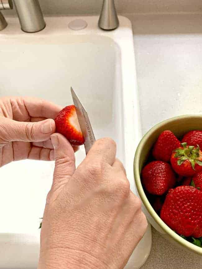 slicing strawberries for a spinach strawberry salad