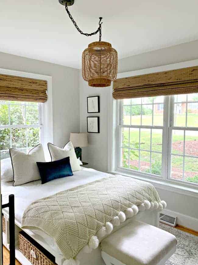 view of guest bedroom with platform bed and DIY rattan light fixture