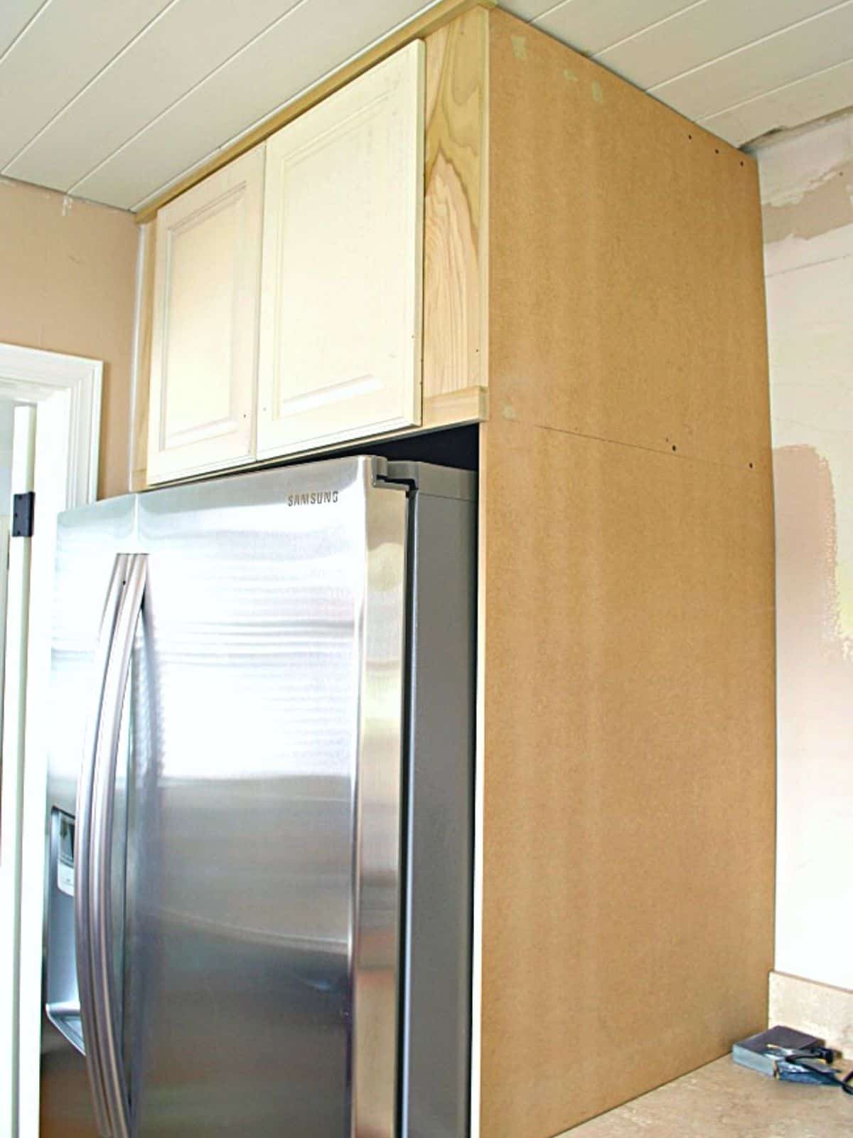 unpainted refrigerator cabinet with doors