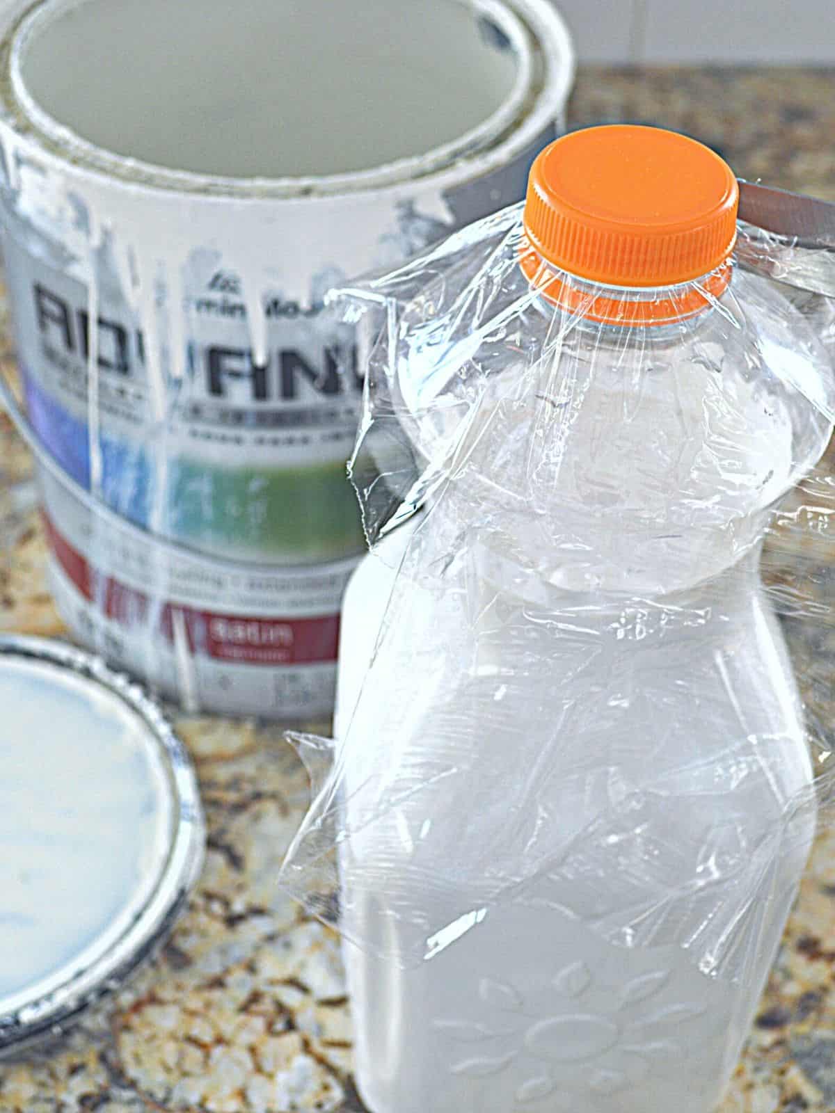 paint in plastic container with orange lid