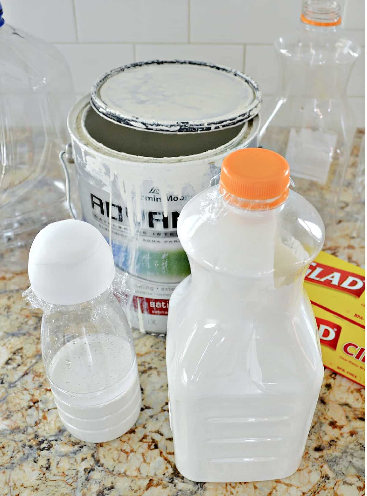 creamer container and plastic container filled with paint