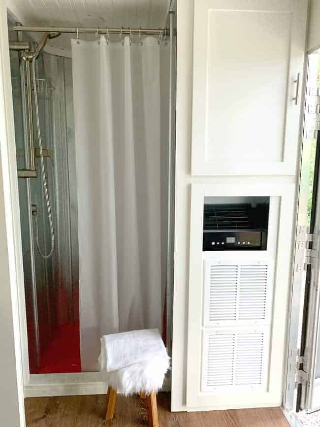 view of DIY shower and a/c unit in cargo trailer
