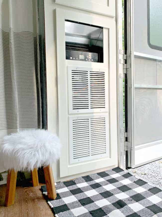 portable a/c cabinet with vents on the front and a faux fur wood stool