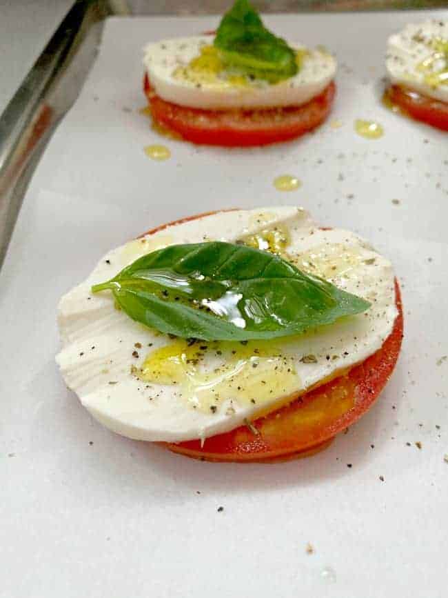 tomato slice with mozzarella and fresh basil 