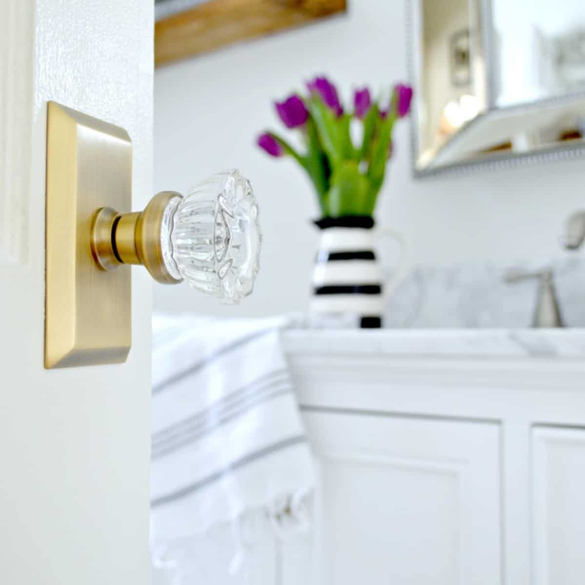 brass and glass door knob on a bathroom door