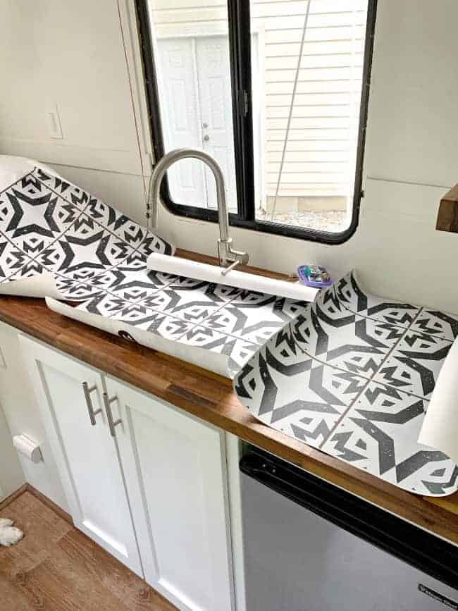 removable wallpaper panels laying on butcher block countertop in RV