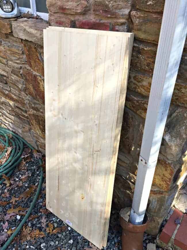 pine planks lined up against stone wall