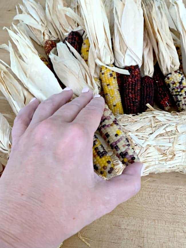 DIY Indian Corn Wreath photo adding mini Indian corn cob to straw wreath form