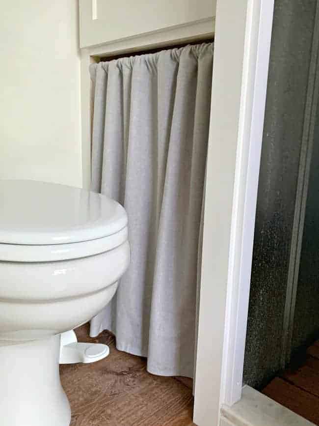 no sew curtain hanging in closet opening next to toilet