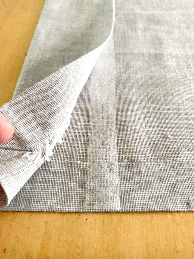 showing iron-on hem tape on cheap no sew curtain