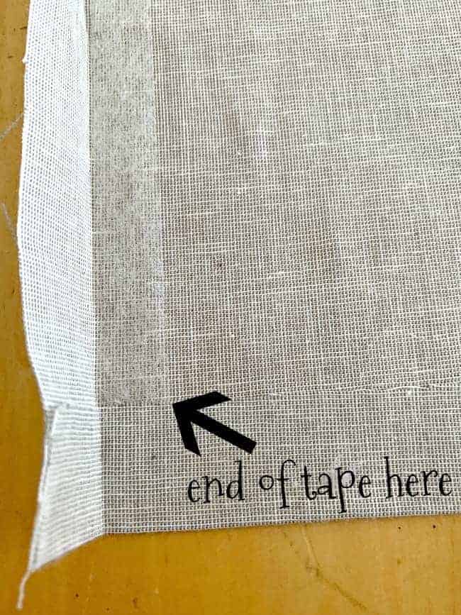 iron-on hem tape in seam of fabric for cheap no sew curtain