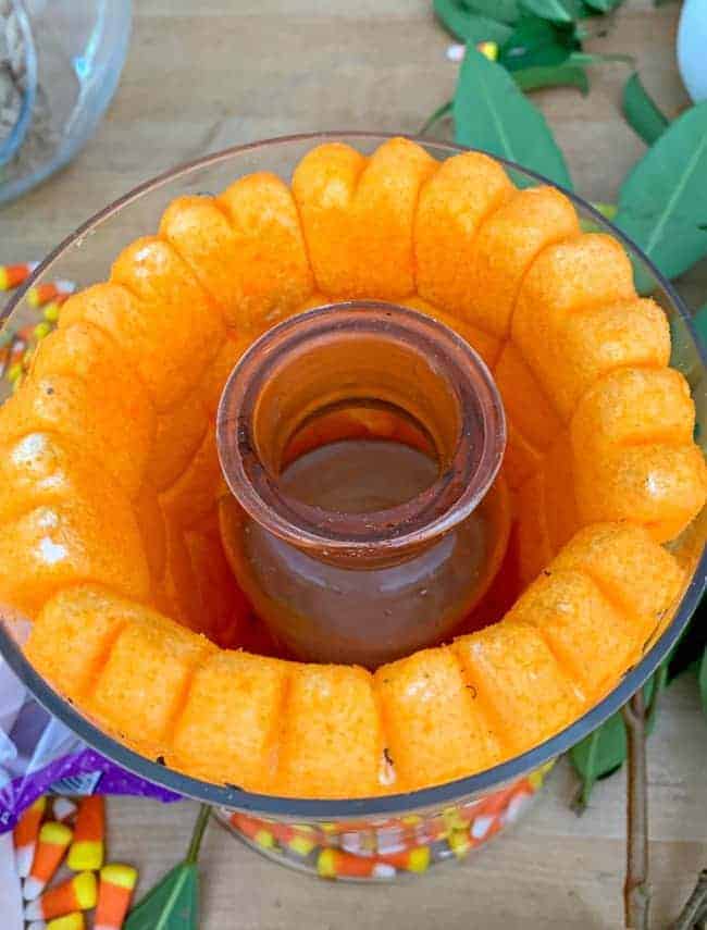 pumpkin marshmallow Peeps in wide glass vase with narrow glass vase in the center