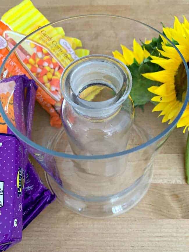 narrow glass vase in a wide glass vase for fun fall centerpiece DIY