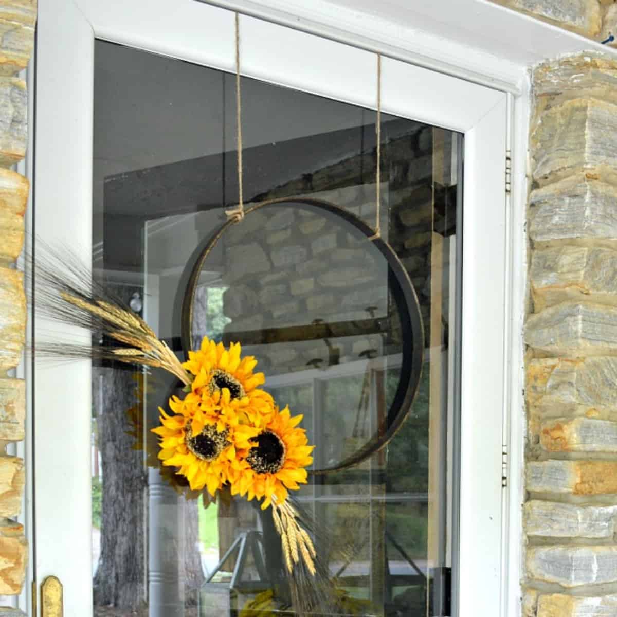 fall hoop wreath with sunflowers hanging on front door