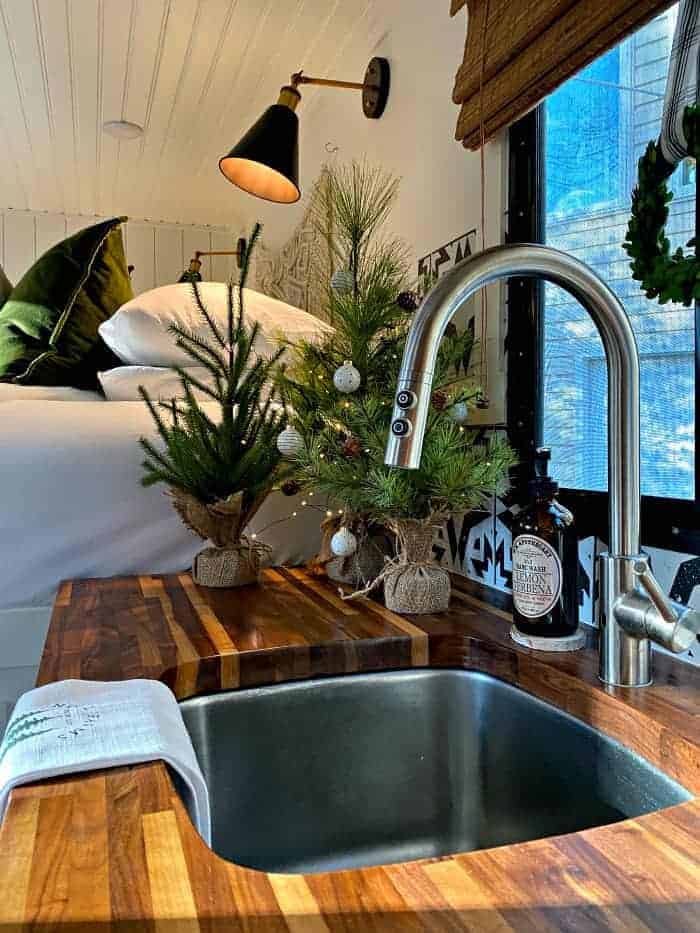 view of RV sink and faux Christmas trees on wood counter