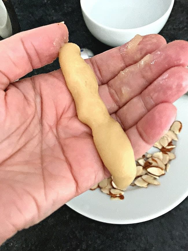 almond horn cookie dough rolled into 3 inch log on hand