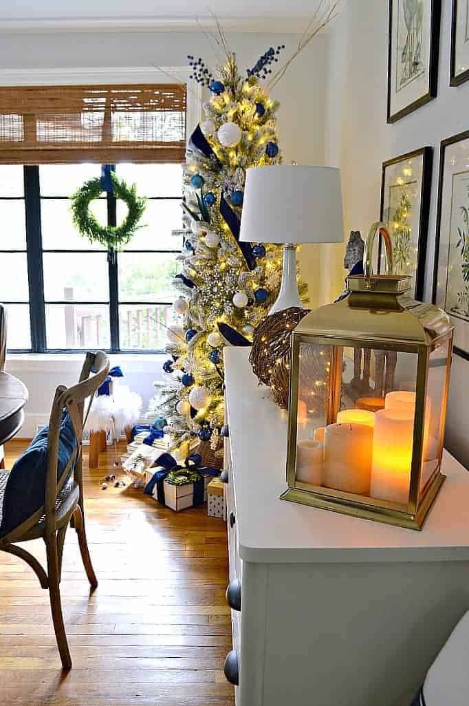 flocked Christmas tree in dining room by window