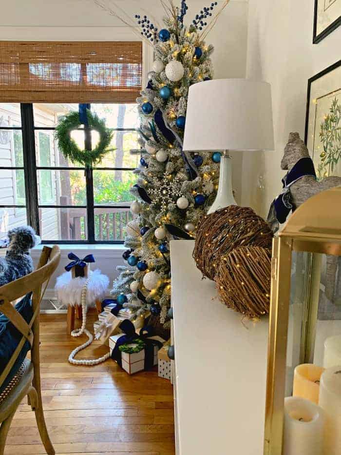 Navy Christmas tree in corner of cottage dining room with presents underneath