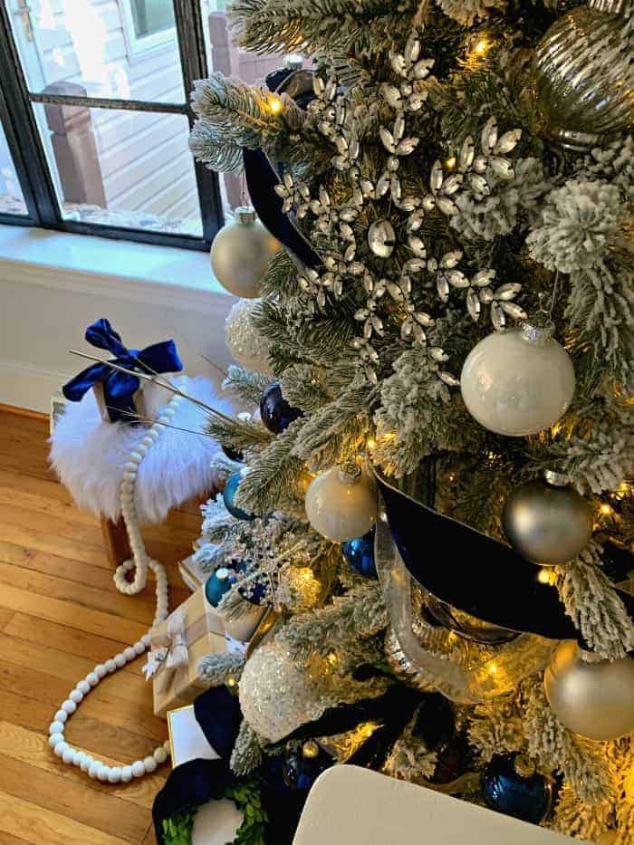 closeup view of navy Christmas tree decor and large crystal snowflake ornament