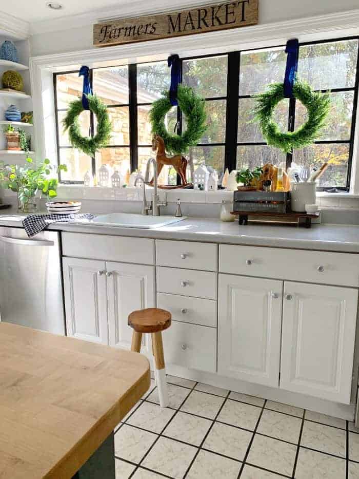 view of kitchen with island and wreaths hung on big window