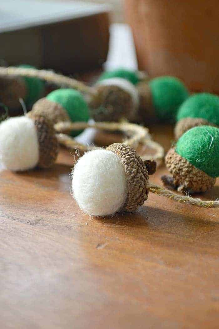 white and green felted acorns