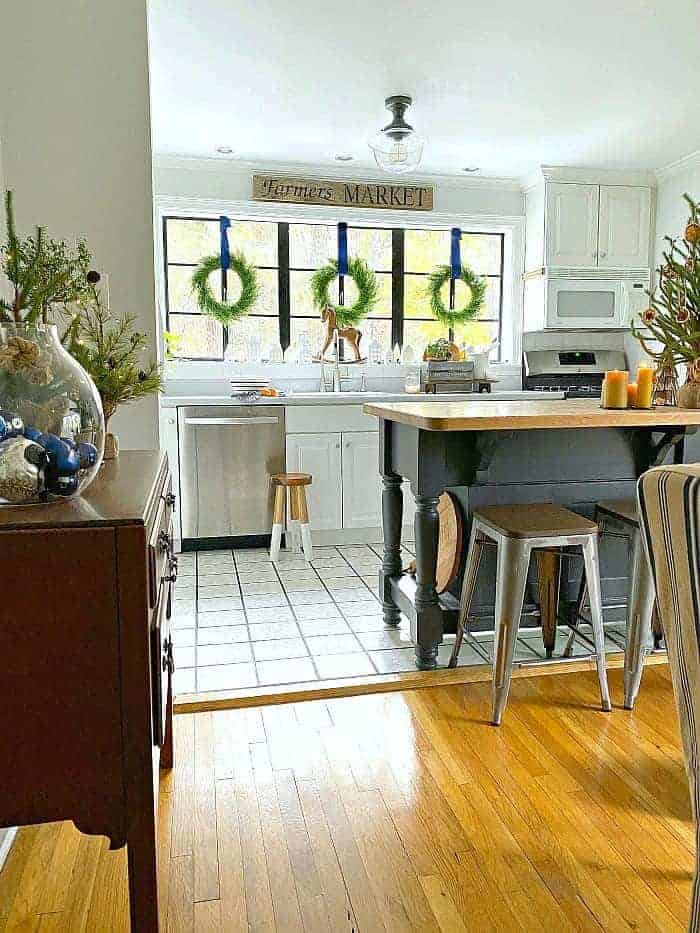 view of kitchen with island and wreaths hung on big window