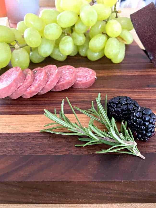 rosemary and blackberries on a DIY cutting board