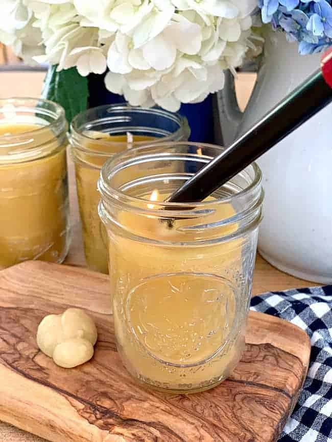 lighting a mason jar beeswax candle