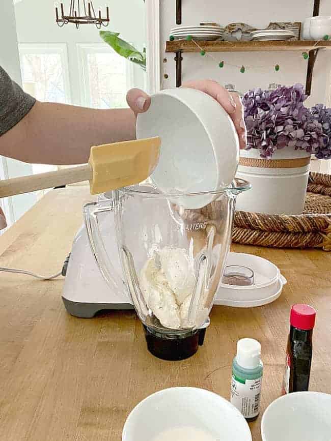 adding vanilla ice cream into a blender