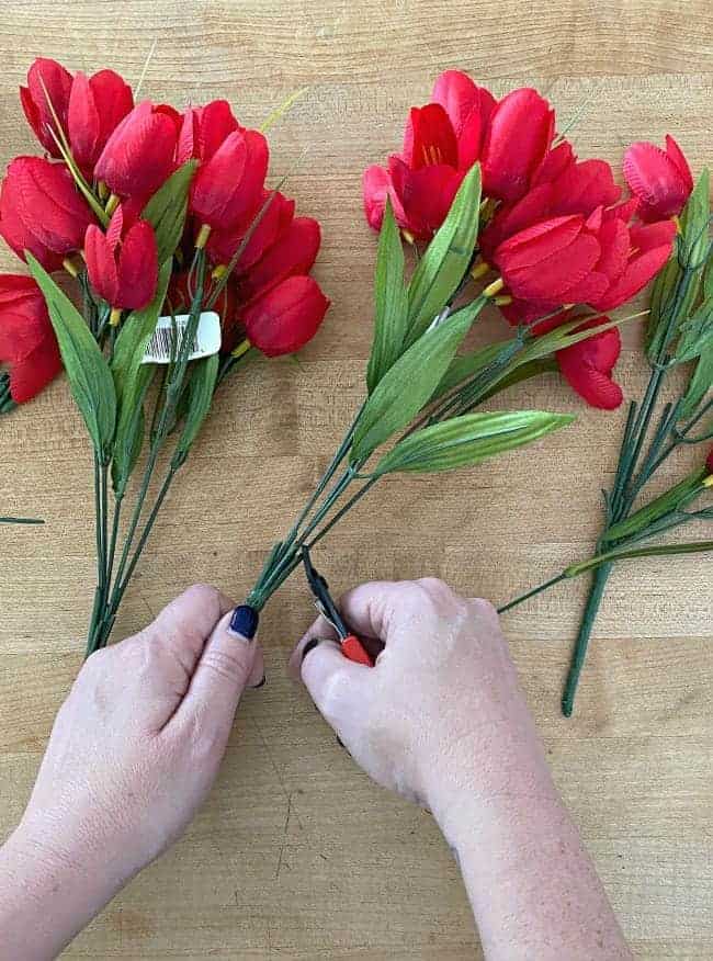 cutting faux red tulips with wire cutters