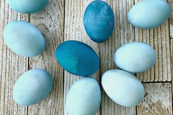 eggs dyed blue with red cabbage on wood planks