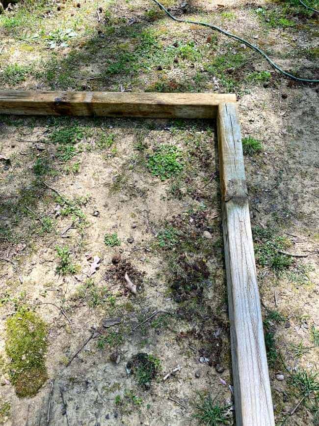 laying out wood planks for raised planter bed