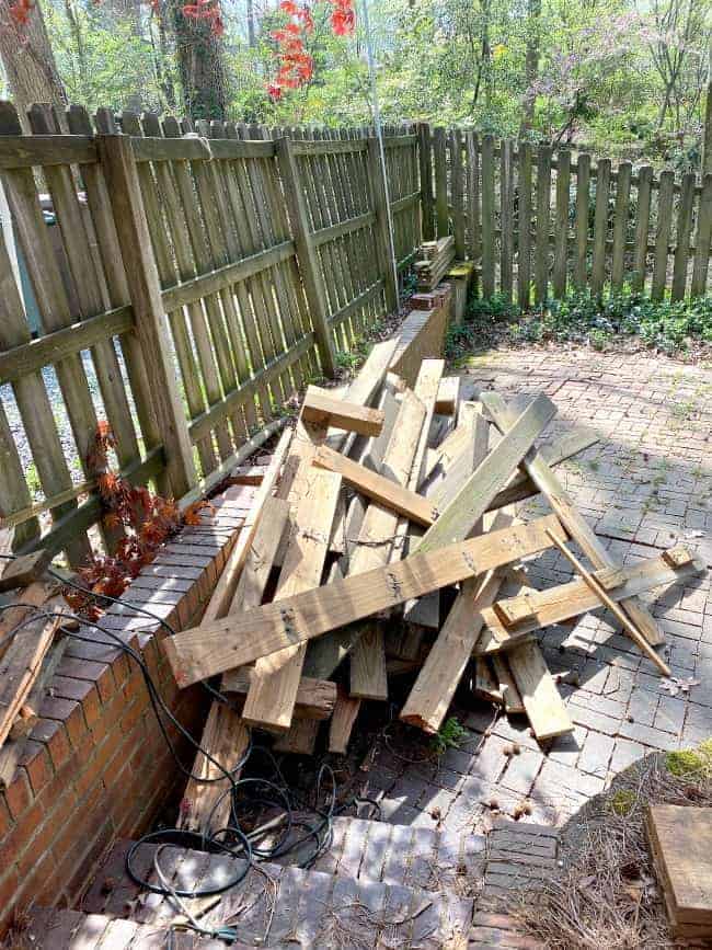 old wood planks piled up on ground