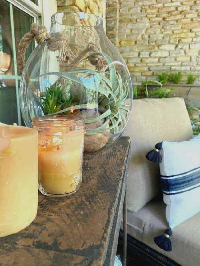 beeswax candles on wood console on front porch