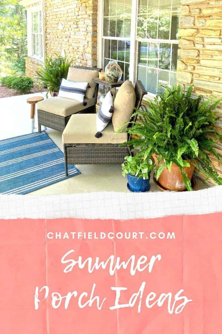 covered front porch decorated for summer with 2 chairs with pillows and potted plants