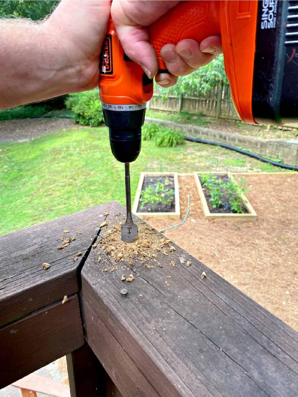 drilling into a wood deck rail
