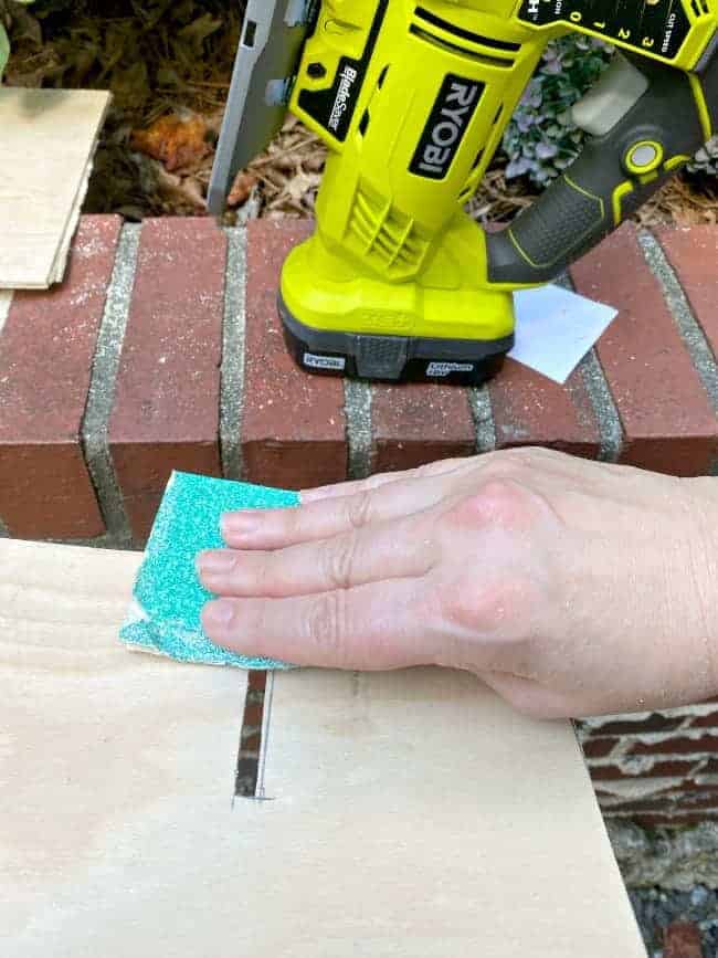 sanding piece of wood with sandpaper