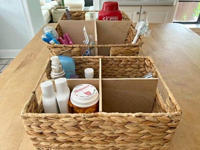 woven baskets on kitchen island with DIY dividers and toiletries in them