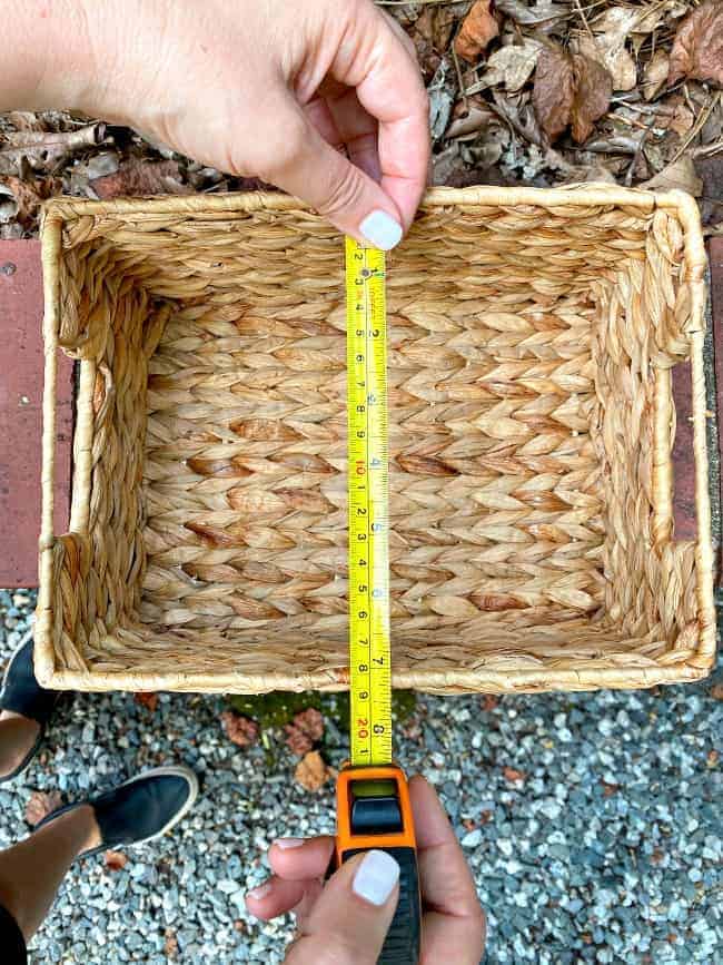 using a tape measure to measure the inside of a woven basket