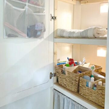 woven basket with DIY dividers in linen closet filled with toiletries