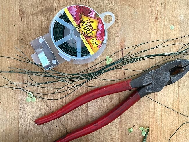 wire cutter and floral wire on a butcher block cutting board