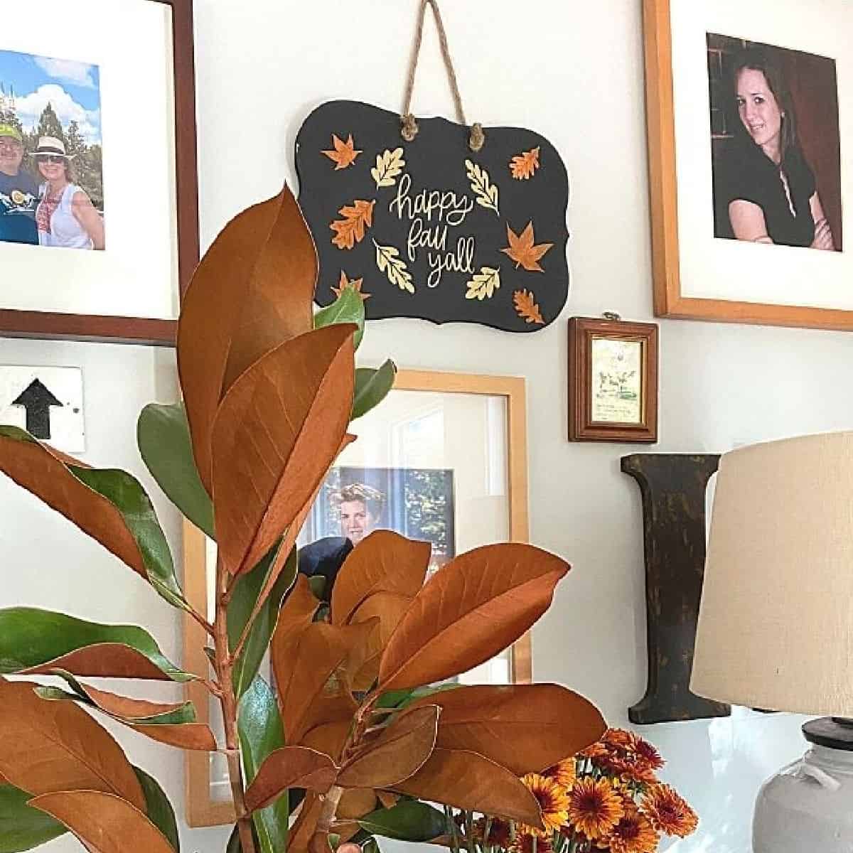 DIY fall sign hanging on wall with other pictures