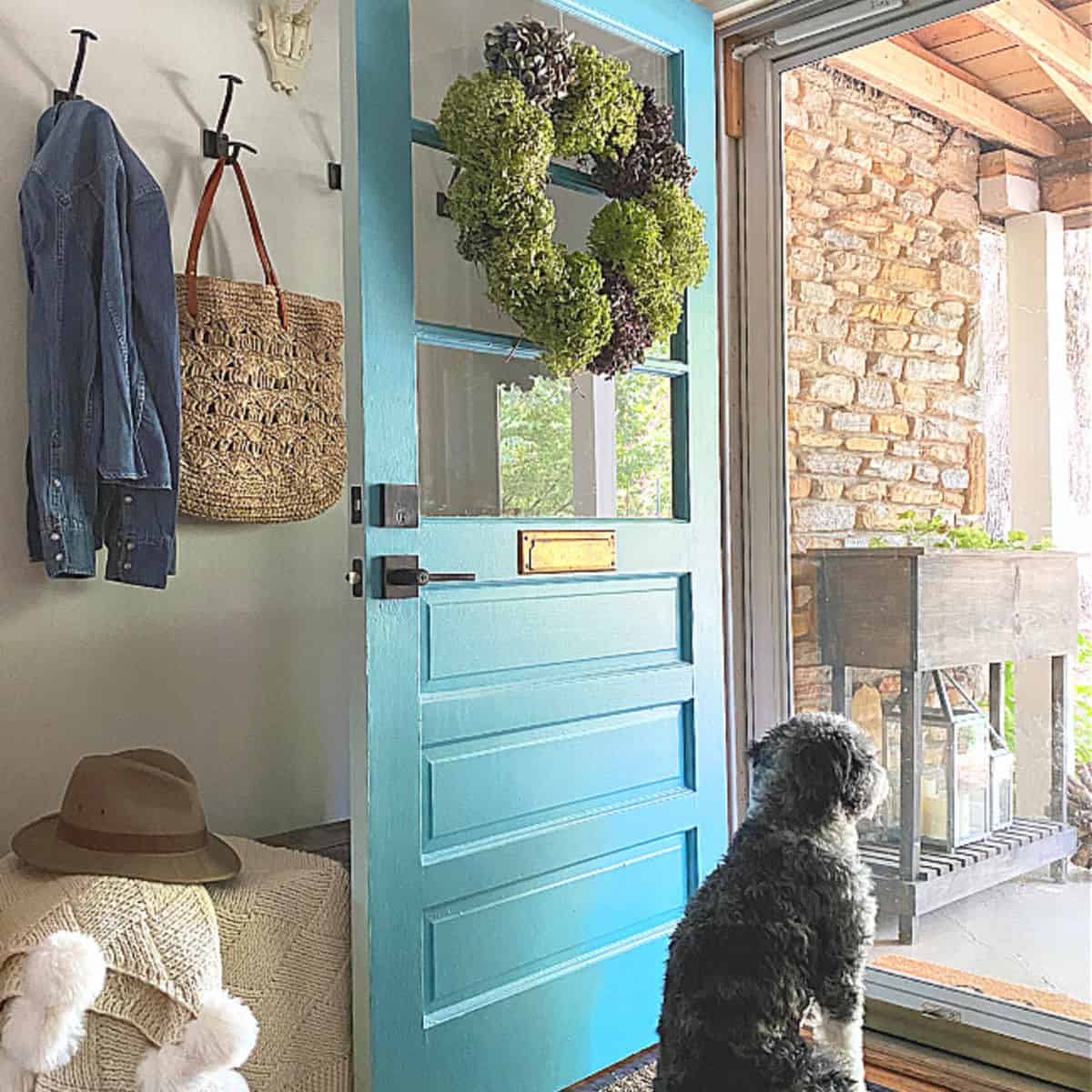 dried hydrangea wreath hanging on a turquoise door